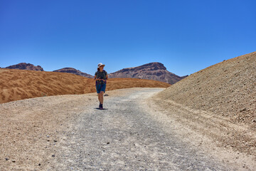Hiker pausing on volcanic trail