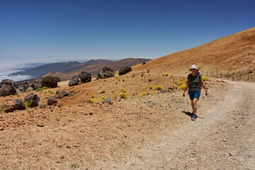 Woman hiking among lava boulders