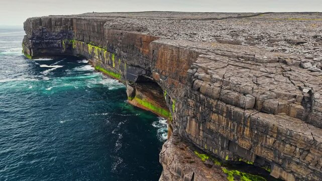 Aerial shot of stunning natural landscapes of Aran Islands with breathtaking cliffs and vibrant coastal views during serene day of adventure. The Arans, Ireland, Galway Bay 