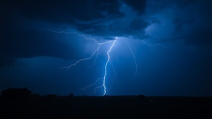 A dramatic lightning strike illuminates the dark stormy sky with electric blue brilliance.