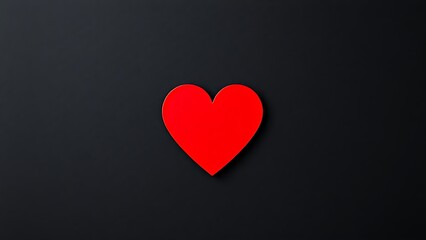 Minimalist red heart shape on a dark textured background, symbolizing emotion and warmth.