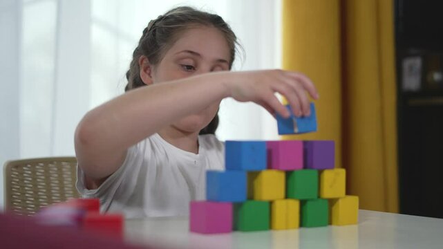 Playtime construction kid development with vibrant blocks. Child in deep play constructing creatively. Developmental play focused kid constructs with blocks. Child creative play in development.