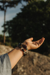 Close-up of female hands holding natural healing stones. Tools for energy balance, emotional...