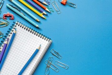 Items for School and Office Pencils, Notebook, Erasers, Paper Clips Are on a Blue Background