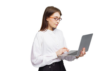 Young woman in stylish attire engaging with laptop while standing against a clean background,...