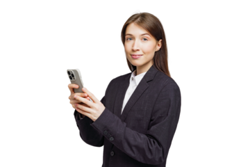 Confident young woman in professional attire engaging with her smartphone in a bright, minimalist setting