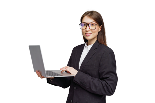 Professional woman in a stylish suit engages with her laptop, showcasing confidence and modernity in a bright setting