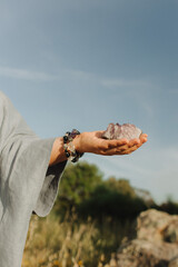 Close-up of female hands holding natural healing stones. Tools for energy balance, emotional...