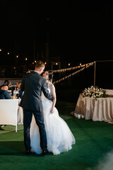 first dance of the bride and groom inside a restaurant