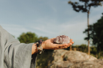 Close-up of female hands holding natural healing stones. Tools for energy balance, emotional support, self-discovery through intention, intuition, gentle presence. Vintage tone. Soft focus, blurred