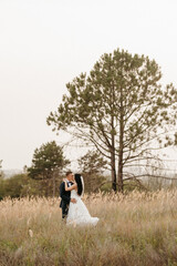 young couple a guy and a girl are walking in the green hills