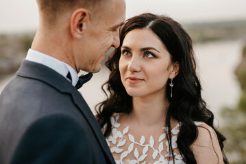 young couple a guy and a girl are walking in the green hills