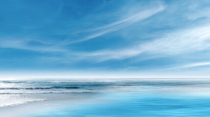 Obraz premium A beautiful blue ocean with a few clouds in the sky
