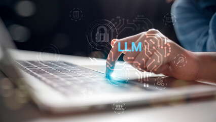 Close-up of hand touching laptop with LLM hologram and cybersecurity icons. Concept of AI language...