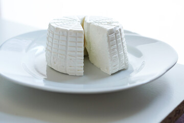 Italian fresh creamy ricotta cheese on white background	