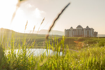 Luxury resort hotel in scenic countryside at golden hour. Perfect travel destination with rolling...