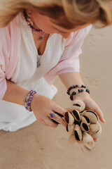 Close-up of female hands holding sound healing instruments. Tools for therapy, inner balance, and...