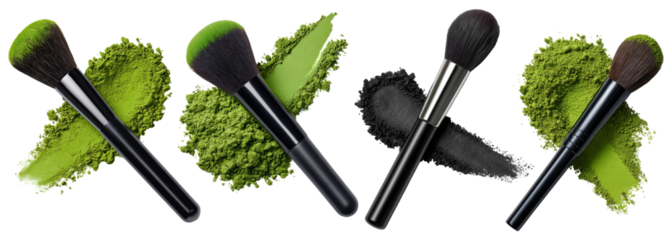 Set of four makeup brushes with green and black powder swatches