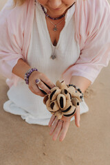 Close-up of female hands holding sound healing instruments. Tools for therapy, inner balance, and...