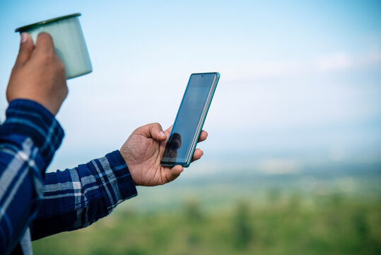 Close up women hands holding coffee cup smartphone E-commerce online Shopping website Reading Article Blog vlog. Young Woman hands holding mobile phone drinking Coffee Cup technology lifestyle