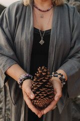 Close-up of female hands holding natural healing stones. Tools for energy balance, emotional...