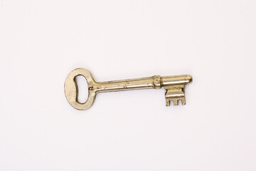 Old rusty door key isolated on white.
