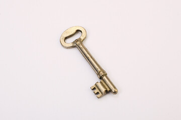 Macro photography of an old and vintage rusty key isolated on white background