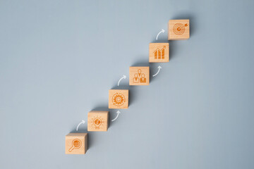 Wooden block stacking as step stair on blue background