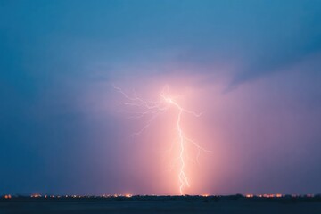 portrait of lone tree silhouetted under branching lightning bolt amid rolling thunderclouds