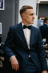 portrait of a young guy groom at the training camp in the barbershop