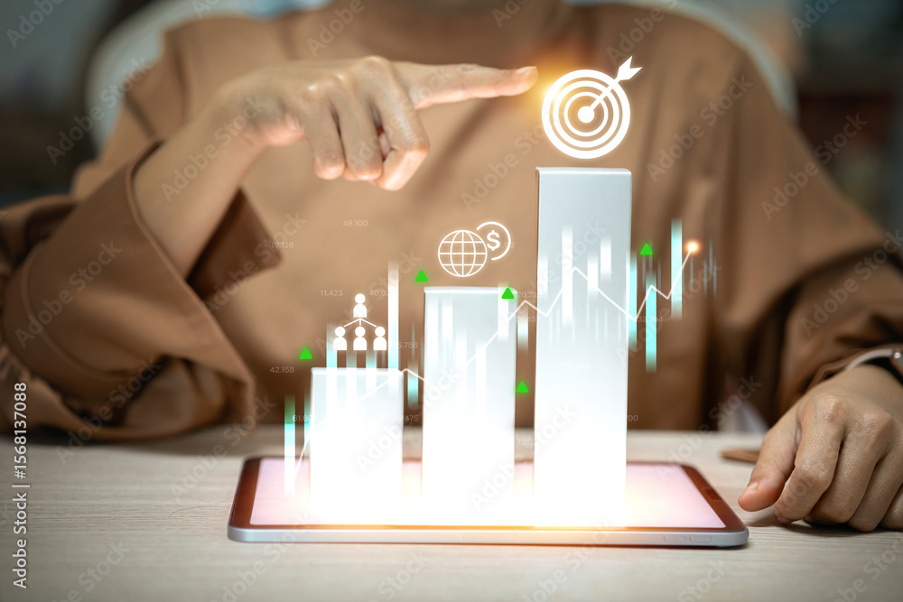 Poster a person points to a target on a digital bar graph rising from a tablet, symbolizing achieving busin