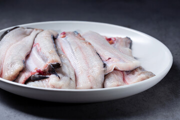raw eel cut into pieces on a plate