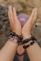 Close-up of female hands holding natural healing stones. Tools for energy balance, emotional...