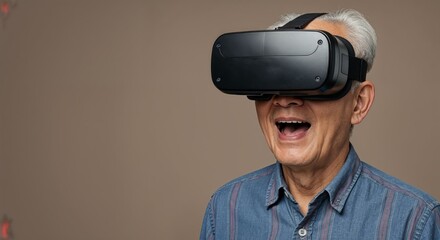 Elderly Asian man with freckles smiling in VR headset against neutral studio background