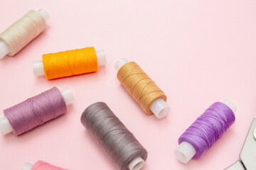 Colorful Threads for Sewing on Pink Background