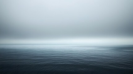 Serene Calm Ocean Surface Under Gray Overcast Sky at Dusk