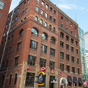 historic brick building facade and sign outside Loose Moose located at 146 Front St W, Toronto