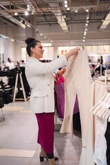 Stylish shopper explores fashion choices in a vibrant boutique