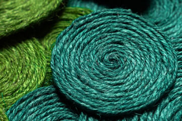 Multicolored knitting threads in golden ratio state, background. Mixed colorful texture of intertwined threads