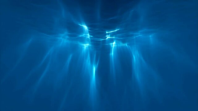 Abstract underwater background with shimmering light rays piercing deep blue water from the surface