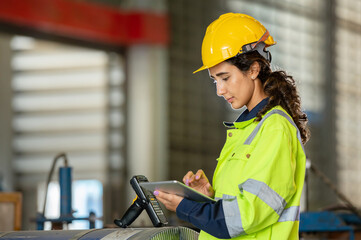 young woman engineer in uniform inspection warehouse and check control heavy machine construction...