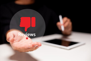A person holds out a hand with a red thumbs-down icon and 
