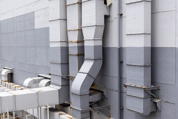 Industrial Ventilation System on Building Exterior. an industrial ventilation and air duct system installed on the exterior wall of a commercial or factory building. engineering and utility.