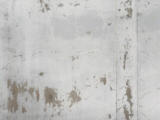 Aged White Wall Texture with Cracks and Peeling Paint. an old, weathered white wall exhibiting...