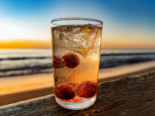 Italian soda drinks with strawberries and lemon slices photographed in front of ocean views