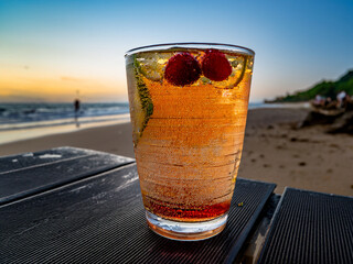 A beach-themed collage of Italian soda drinks with fruit garnishes and sunset lighting