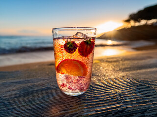 Italian soda drinks with mint leaves and citrus slices photographed at the beach during sunset