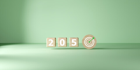 Wooden blocks spelling 2050 next to a target icon on green background, symbolizing long-term goal...