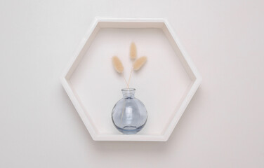 Hexagonal wall shelf and vase with dry flower