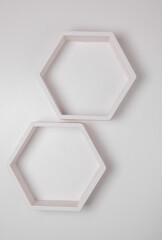 Hexagonal honeycomb shelves on white wall background
